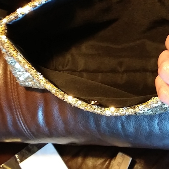 Gold Victoria's secret bag filled with a variety of beauty products. - Picture 5 of 13